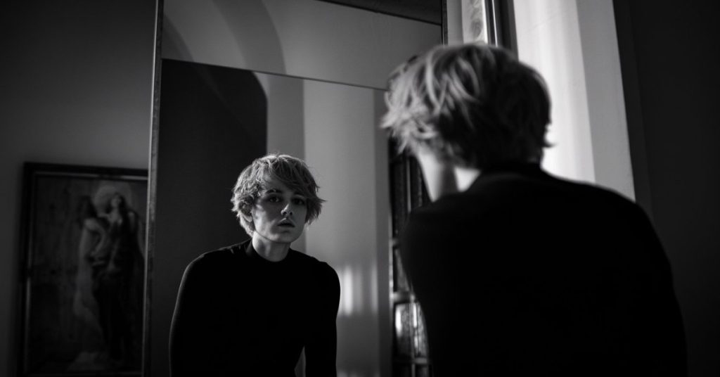 rtistic reflection in a mirror representing the subconscious shadow self and emotional honesty.